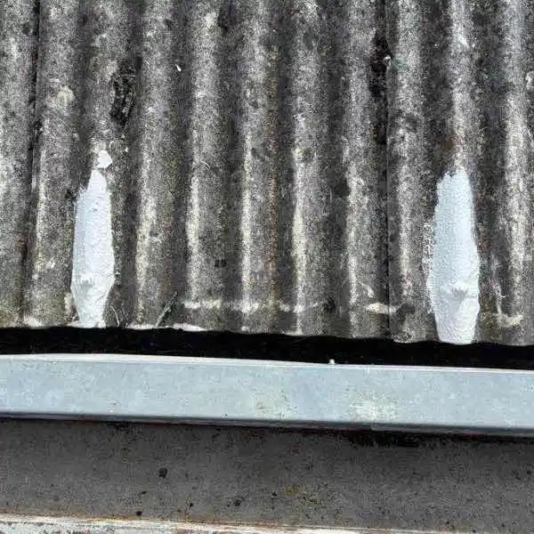 Professional Lava 20 waterproofing system applied to asbestos roof bolt penetrations showing instant-cure repair sealing metal fastener leaks
