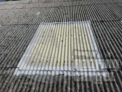 Rooflight seal repair on asbestos roof showing waterproofing treatment