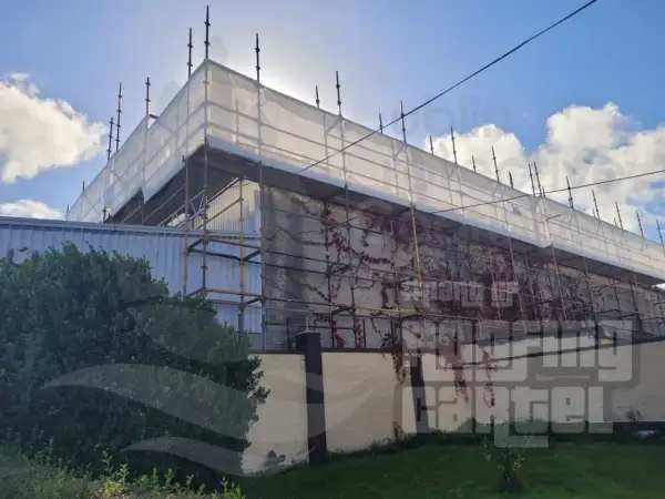 Polyurea waterproofing coating applied to large industrial warehouse asbestos roof in Dublin