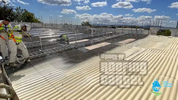 Spray foam layer being applied to retail warehouse asbestos roof surface in Dublin