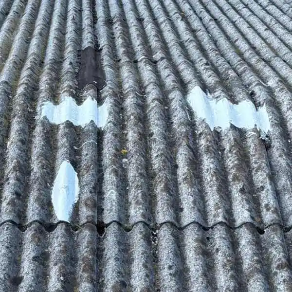 Lava 20 patch repair application on asbestos roof demonstrating seamless waterproofing membrane formation with chemical-resistant coating for long-term protection